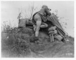 Soldier with binoculars at observation post